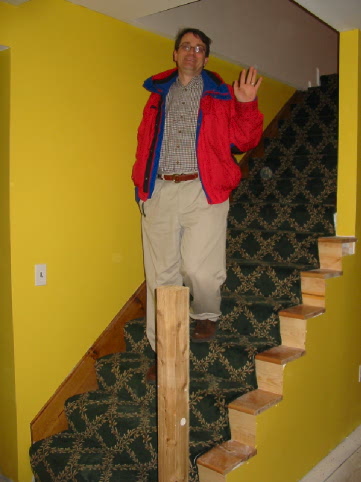 Randy descending 2nd floor stairs with carpet